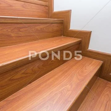 Wooden staircase made from laminate wood in white modern house Stock Photos