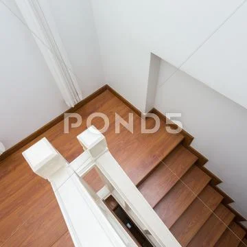 Wooden staircase made from laminate wood in white modern house Stock Photos