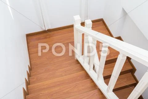 Wooden staircase made from laminate wood in white modern house Stock Photos