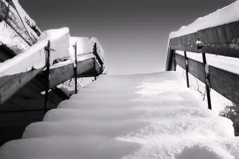 Wooden stairs covered in winter snow Foto stock