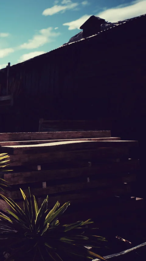 Wooden steps sit in shadow near a building with blue sky Stock Footage 339040079