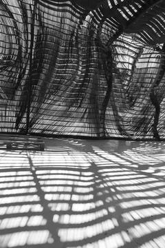 Wooden strip structure with dynamic shadows on the floor Fotos de archivo