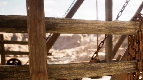 Wooden structure with chains and landscape in the background during daytime Stock Footage 343947729
