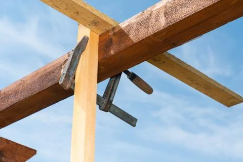 Wooden structure is held together with a clamp Stock Photos