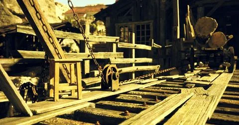 Wooden structures in a deserted mining town at golden hour Illustrazione stock