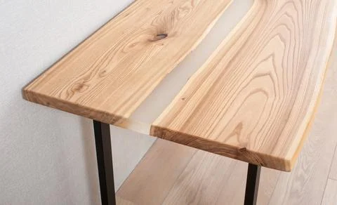 Wooden stylish table made of solid wood with epoxy resin on the background of Stock Photos