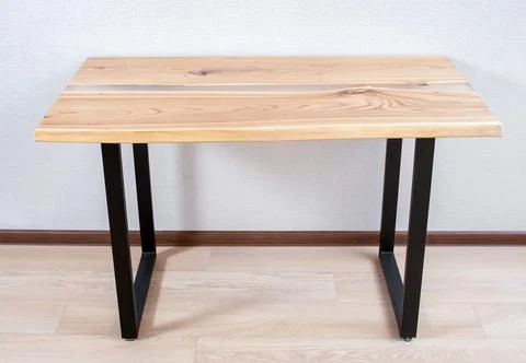 Wooden stylish table made of solid wood with epoxy resin on the background of Stock Photos