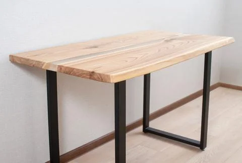 Wooden stylish table made of solid wood with epoxy resin on the background of Stock Photos