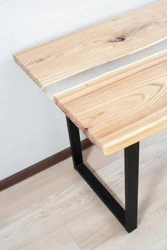 Wooden stylish table made of solid wood with epoxy resin on the background of Stock Photos