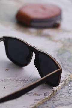 Wooden Sunglasses Over Map Stock Photos