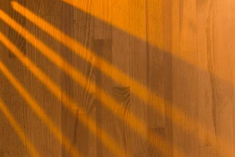 Wooden surface as background texture with rays of light. Stock Photos