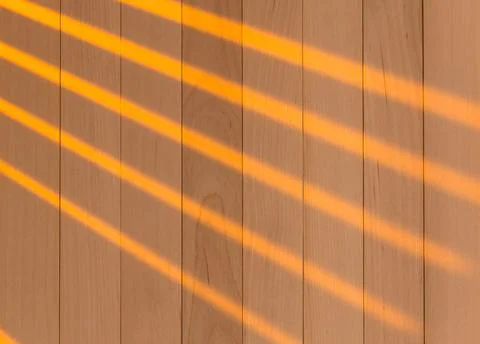 Wooden surface as background texture with rays of light. Stock Photos