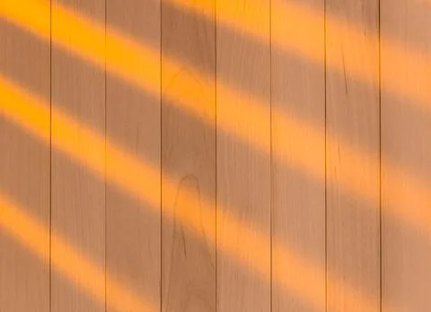 Wooden surface as background texture with rays of light. Stock Photos