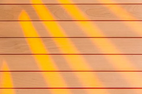 Wooden surface as background texture with rays of light. Stock Photos