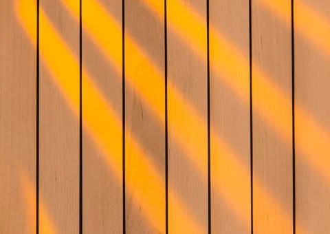 Wooden surface as background texture with rays of light. Stock Photos