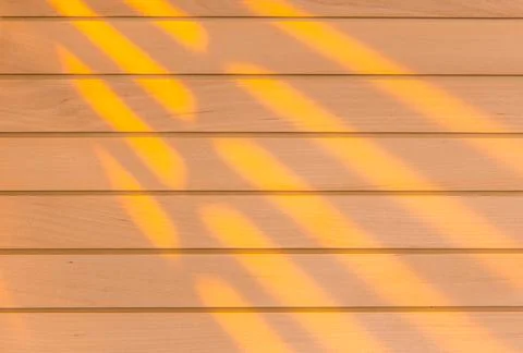 Wooden surface as background texture with rays of light. Stock Photos