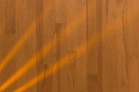 Wooden surface as background texture with rays of light. Stock-Fotos