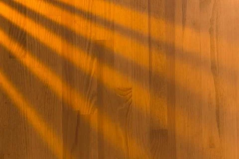 Wooden surface as background texture with rays of light. Stock Photos