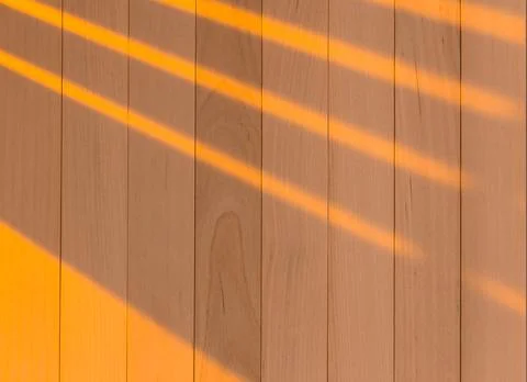 Wooden surface as background texture with rays of light. Stock Photos