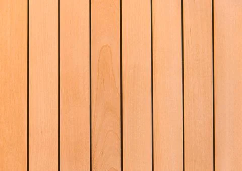 Wooden surface as background texture with rays of light. Stock Photos