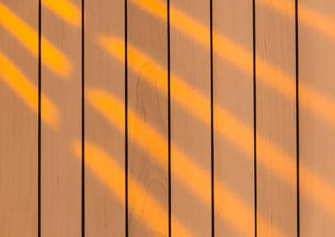 Wooden surface as background texture with rays of light. Stock Photos