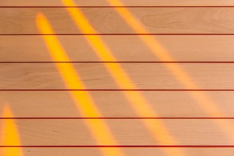 Wooden surface as background texture with rays of light. Stock Photos