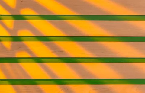 Wooden surface as background texture with rays of light. Stock Photos