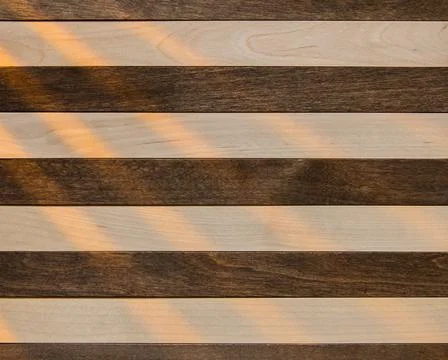 Wooden surface as background texture with rays of light. Stock Photos