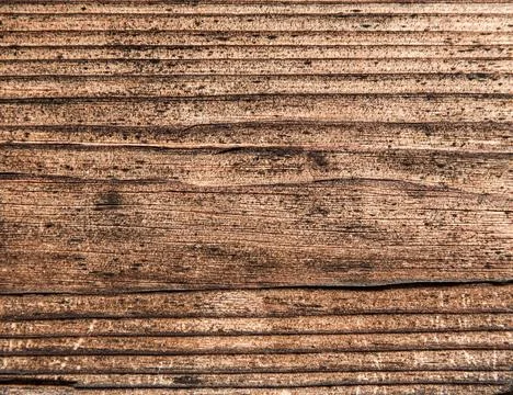 Wooden surface as background texture with rays of light. Stock Photos