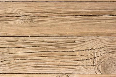 Wooden surface as background texture with rays of light. Stock Photos