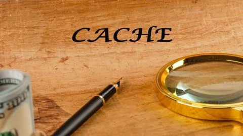 A wooden surface features the word cache prominently, accompanied by a magnif Stock Photos