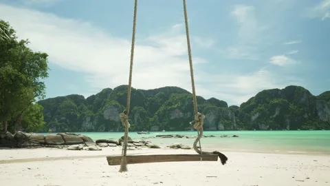 Wooden swing hang with view Phi Phi island, Thailand in summer season Stock Footage 153506090