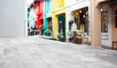 Wooden table and blurred street scene in the background Stock Photos