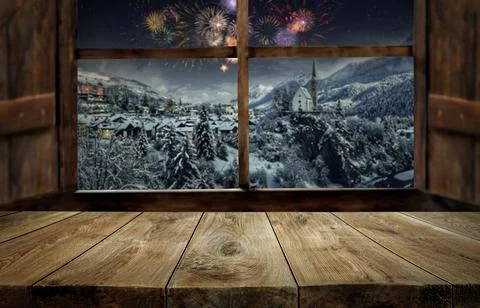 Wooden table and window with blurred christmas scene and fireworks Stock Photos
