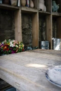 Wooden Table with Blurred Workshop Background and Copy Space. Country farmhouse Stock Photos