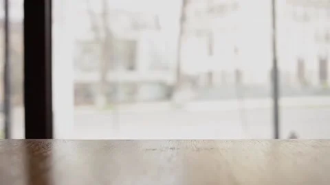 A wooden table in a cafe. A panoramic window overlooking the city Stock Footage 152459344