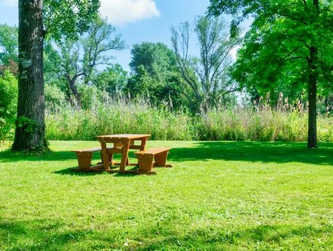 Wooden table with chairs for picnic and resting in Donau Park Vienna, Austria Stock Photos