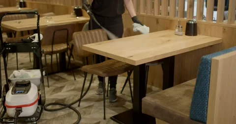 Wooden Table Cleaned With Steam Cleaner in a Restaurant Video stock 340276160
