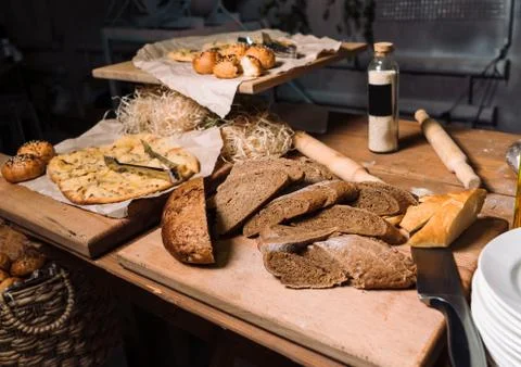 Wooden table with different types of bread. Loft decoration. 스톡 사진