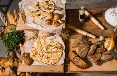 Wooden table with different types of bread. Top view. Stockfoto's