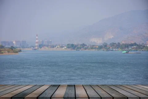 Wooden table on empty on blurry river. Stock Photos