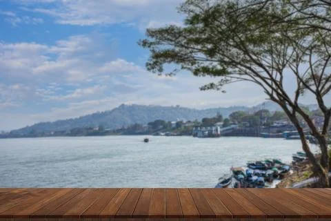 Wooden table on empty on blurry river. Stock Photos