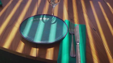 Wooden table with empty, clean dishes and wine glasses Stock Footage 147684599