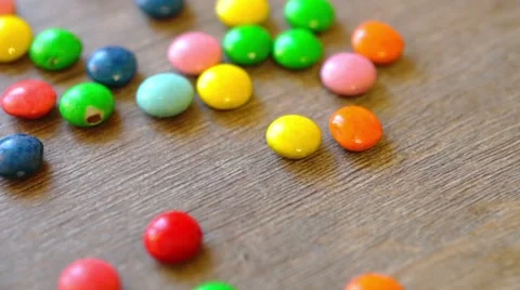 Wooden table with falling candies Stock-Footage 41735048