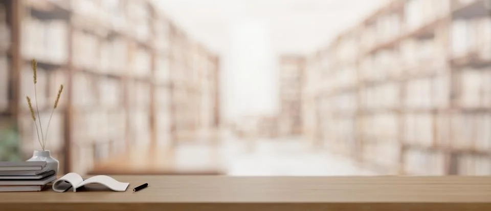 A wooden table features a presentation space with a blurred library in the .. イラスト素材