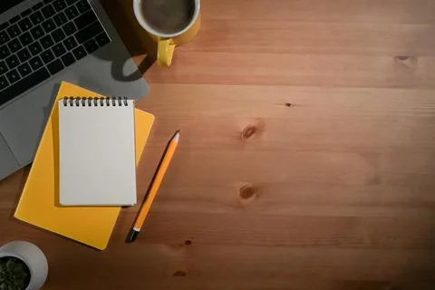 Wooden table with laptop computer, notebook and coffee cup. Flat lay, Top view Stock Photos