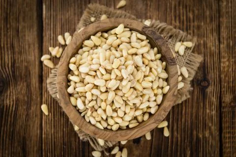 Wooden table with Pine Nuts (selective focus) Foto stock