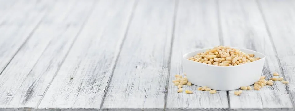  Wooden table with Pine Nuts (selective focus) Pine Nuts on rustic wooden ... Foto stock