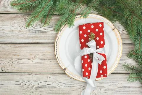 Wooden table with pine tree branches and holiday table setting Stock Photos