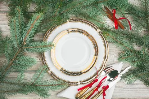 Wooden table with pine tree branches and holiday table setting Stock Photos